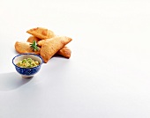 Dumpling stuffed with cheese and guacamole in bowl on white background