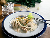 Poularde with vegetables and cream sauce on plate