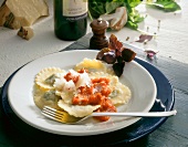 Tortelli with chicken filling and tomato sauce on plate