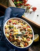 Pasta gratin with chicken, peppers and cheese in casserole