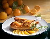 Crispy baked duck with orange sauce on plate
