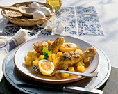 Chicken with potatoes and boiled eggs gravy on plate
