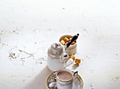 Chocolate drink, jug and sugar cubes on white background