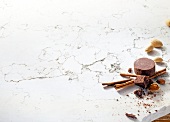 Chocolate pieces with almonds, cinnamon on white background