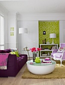 Living room with purple sofa, upholstered chair and white table against green niche