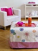 White spotted chair with cushion and embroidered flower pattern table