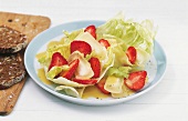 Strawberry salad with limburger cheese and whole grain bread on plate