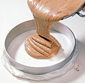 Close-up of dough being poured in cake ring, step 5
