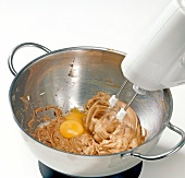 Close-up of egg yolk being added in batter, step 3