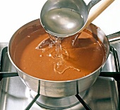 Close-up of sugar syrup being added in mixture, step 4