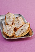 Four trout crostinis on silver plate