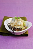 Gorgonzola risotto on portobello mushroom in bowl on olive green table mat