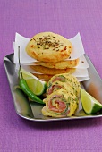 Potato and herb rolls with green chilli and lemon slices on serving plate
