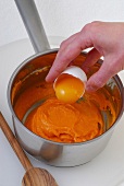 Close-up of egg yolk being added in mixture, step 2