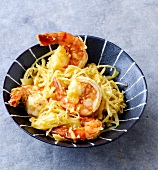 Coconut shrimp with cabbage, onions and turmeric in bowl