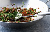 Close-up of vegetables and minced meat in wok, step 2
