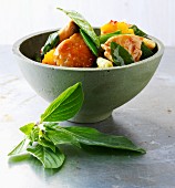 Stir-fried sweet-and-sour chicken with mango and Thai basil