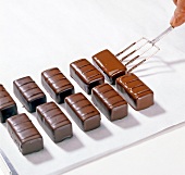 Close-up of dipped chocolates being kept on paper, step 4