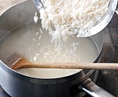 Close-up of basmati rice being poured in boiling water, step 2
