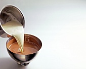 Close-up of sahne being poured in melted chocolate, copy space