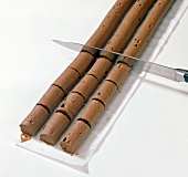 Close-up of ganache cream being sliced into pieces, step 2