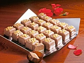 Amaretto truffle cubes in serving dish with red flower