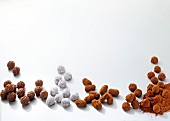 Close-up of nutmeg and honey truffle on white background
