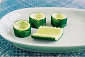 Close-up of three cucumbers turrets and cucumber boat on dish