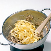 Pasta noodles with hazelnut mixture in bowl, step 4
