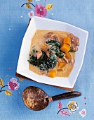 Pumpkin curry with pork, spinach and coconut milk in bowl