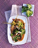 Broccoli with oyster mushrooms, coconut chips and lemon grass in dish