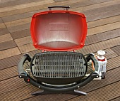 Rectangular shaped gas grill with red cap