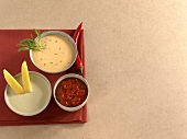 Barbecue sauce, bearnaise sauce and mustard cream sauce in bowls