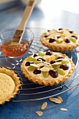 Three grapes tart with quince jelly and brush on cake rack 