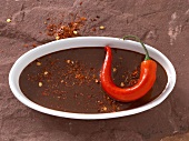 Chilli and chocolate sauce on oval plate