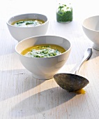 Two bowls of potato soup with watercress pesto