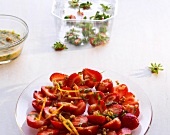 Strawberries with orange almond pesto and lemon balm on plate
