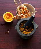 Chicken skewers with saffron and mango pesto in mortar