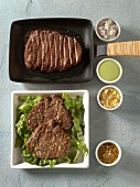 Beef bulgogi in sauce pan and bowl of kobe tenderloin steaks