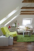 Living room with green armchair and white sofa in attic