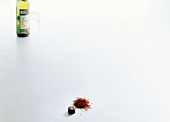 Vermouth bottle, glass and saffron threads on white background