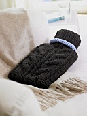 Knitted hot water bottle on shawl