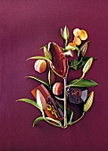 Three perfume bottles and peaches on branches against purple background