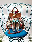Floral cotton leather bag, floral ballerinas and hair combs on chair