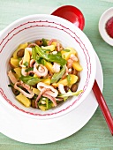 Octopus salad with potatoes, olives and rocket in bowl