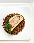 Close-up of lentil with salmon pate and seaweed leaves on plate