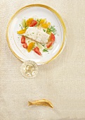 Poached turbot with citrus fruits and fennel on plate, overhead view