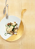 Turbot with cockles, samphire and clams on plate, overhead view