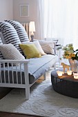 Striped scatter cushions on sofa with wooden frame