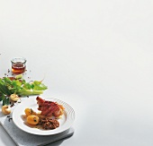 Pickled pork knuckle with lentils and potatoes on white background, copy space